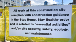 Construction fence with text on it.