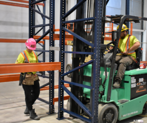 Racking Installation services being done in a warehouse.