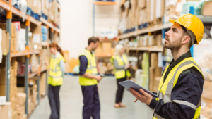 Employees reviewing losses in a warehouse.