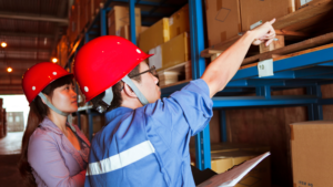 Two employees reviewing a racking system.