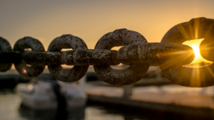 A steel chain by a dock.